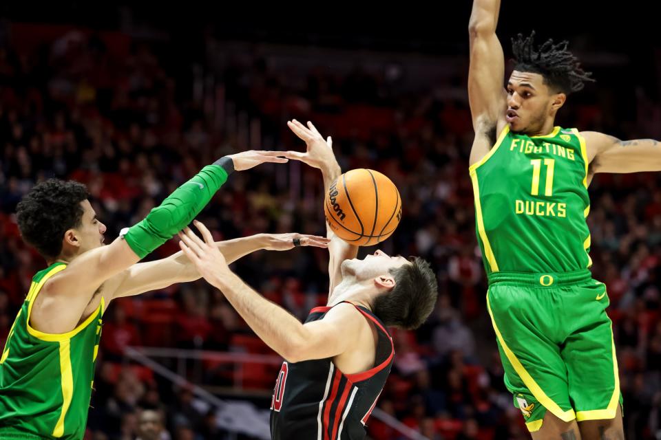 Oregon Ducks guard Will Richardson (0) strips the ball from Utah Utes guard Lazar Stefanovic (20) during the game at the Huntsman Center in Salt Lake City on Saturday, Jan. 7, 2023. | Spenser Heaps, Deseret News