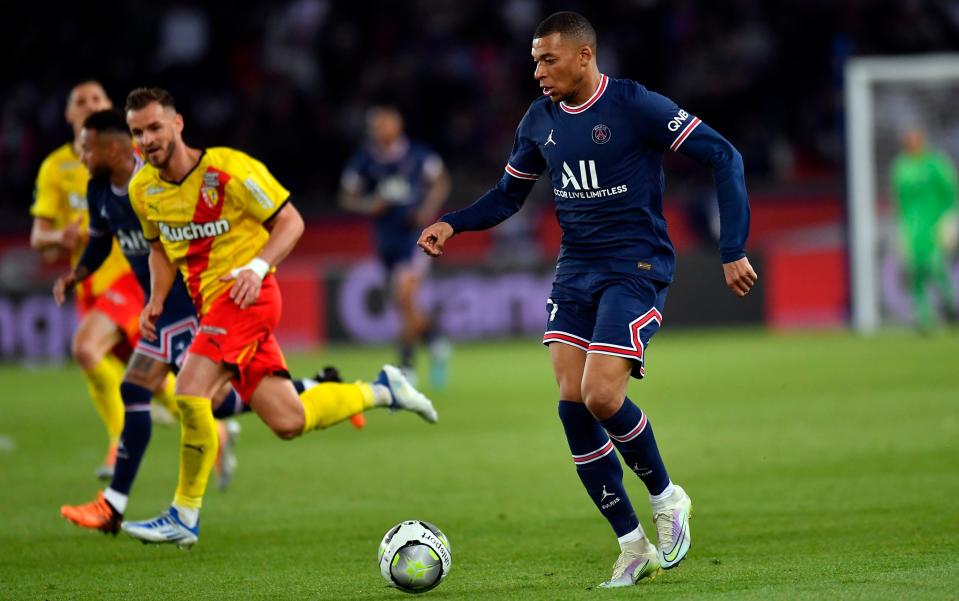 Kylian Mbappe of Paris Saint-Germain runs with the ball during the Ligue 1 Uber Eats match between Paris Saint Germain and RC Lens - Getty Images