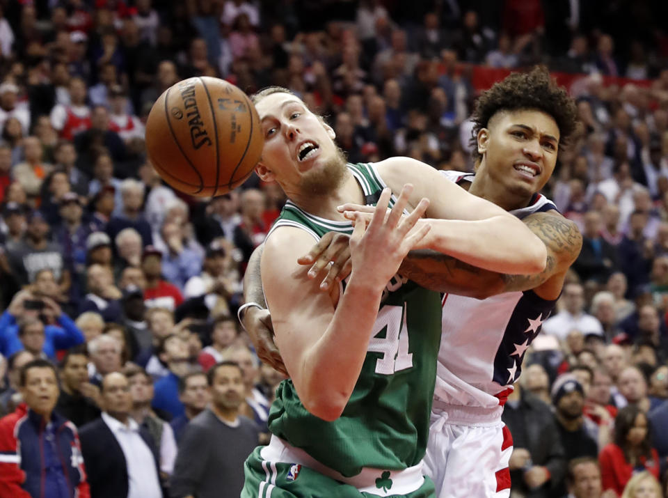 Boston Celtics center Kelly Olynyk is fouled by Washington Wizards forward Kelly Oubre Jr. on an inbounds pass during the fourth quarter of Game 6. (AP)