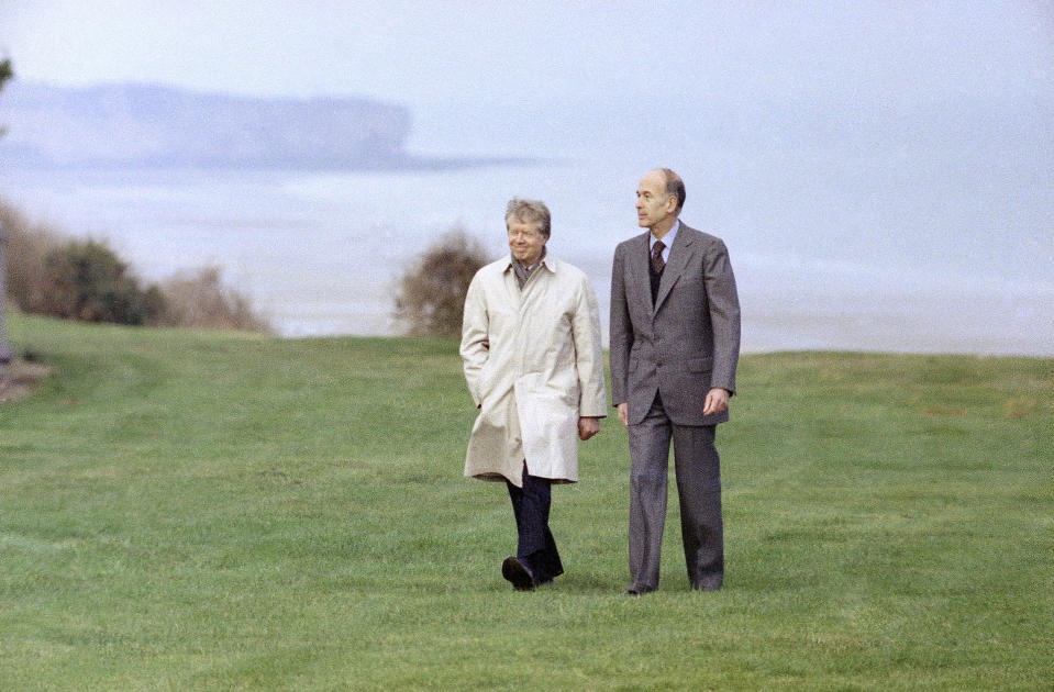 FILE - In this Jan,5, 1978 file photo, President Jimmy Carter walks with French President Valery Giscard D'Estaing at Omaha Beach, Normandy, in France. Valery Giscard d’Estaing, the president of France from 1974 to 1981 who became a champion of European integration, has died Wednesday, Dec. 2, 2020 at the age of 94, his office and the French presidency said. (AP Photo, File)