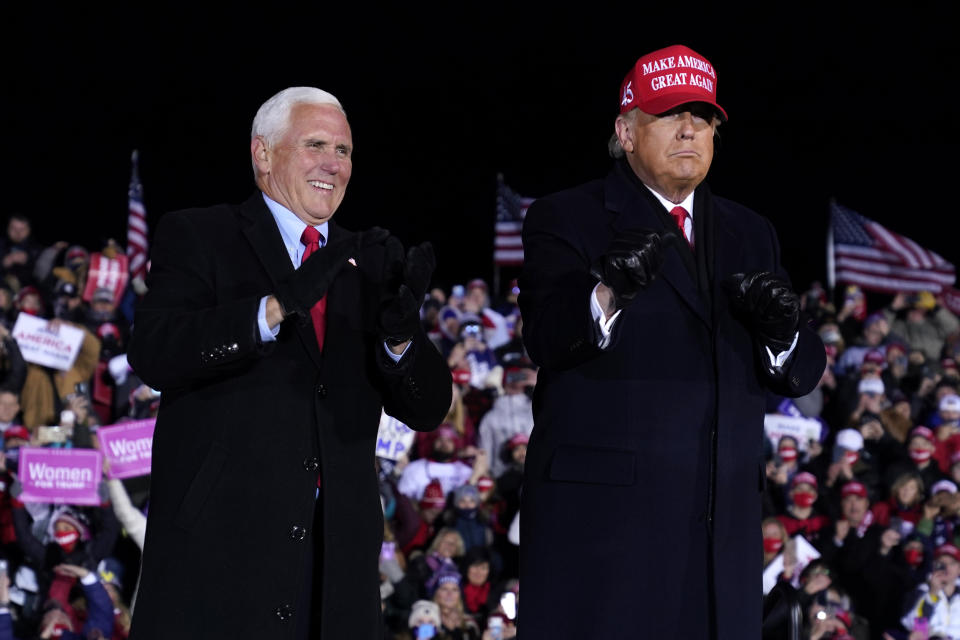 President Donald Trump and Vice President Mike Pence smile after a campaign rally at Gerald R. Ford International Airport, early Tuesday, Nov. 3, 2020, in Grand Rapids, Mich. (AP Photo/Evan Vucci)