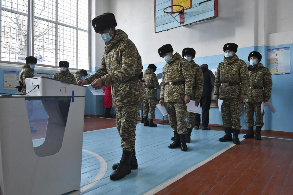 Soldiers vote during the parliamentary elections at a polling station in Besh-Kungei, 15 kilometers (9 miles) south of Bishkek, Kyrgyzstan, Sunday, Nov. 28, 2021. Voters in Kyrgyzstan cast ballots in a parliamentary election Sunday that comes just over a year after a forceful change of government in the ex-Soviet Central Asian nation. (AP Photo/Vladimir Voronin)