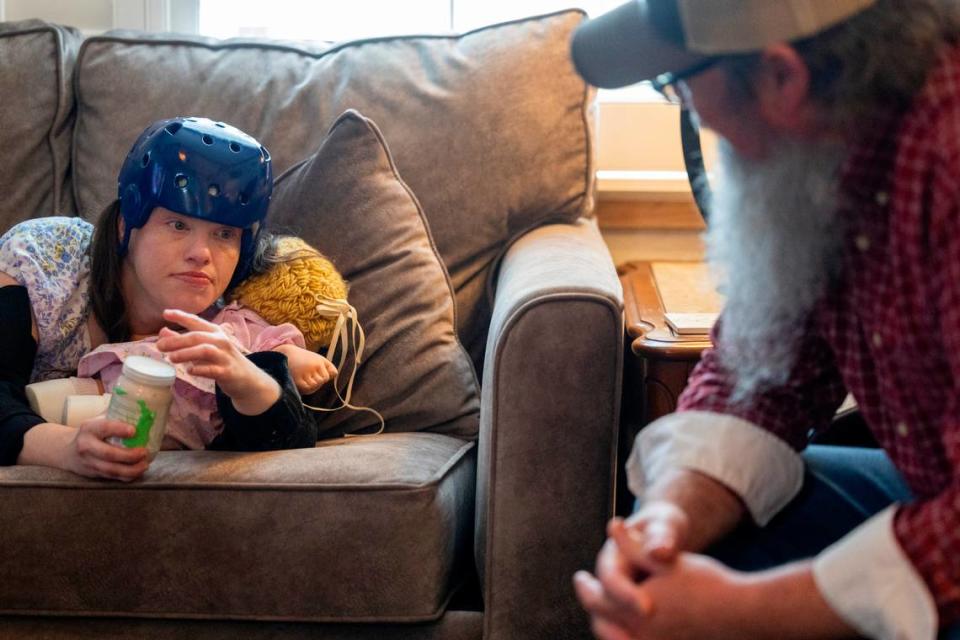 Tim Rhoney spends time with his daughter Samantha, who has a moving disorder and an intellectual disability, at their home near Claremont on Tuesday, April 23, 2024. The Rhoneys filed a lawsuit in 2017 that became known as the Samantha R. case. Disability Rights NC argued that the failure to provide access to community- and home-based behavioral health services violated the rights of people with disabilities.