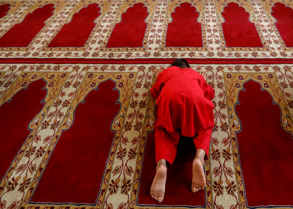An Afghan boy prays during the Muslim festival of Eid al-Adha, amid the spread of the coronavirus disease (COVID-19), in Kabul, Afghanistan July 31, 2020. REUTERS/Mohammad Ismail TPX IMAGES OF THE DAY