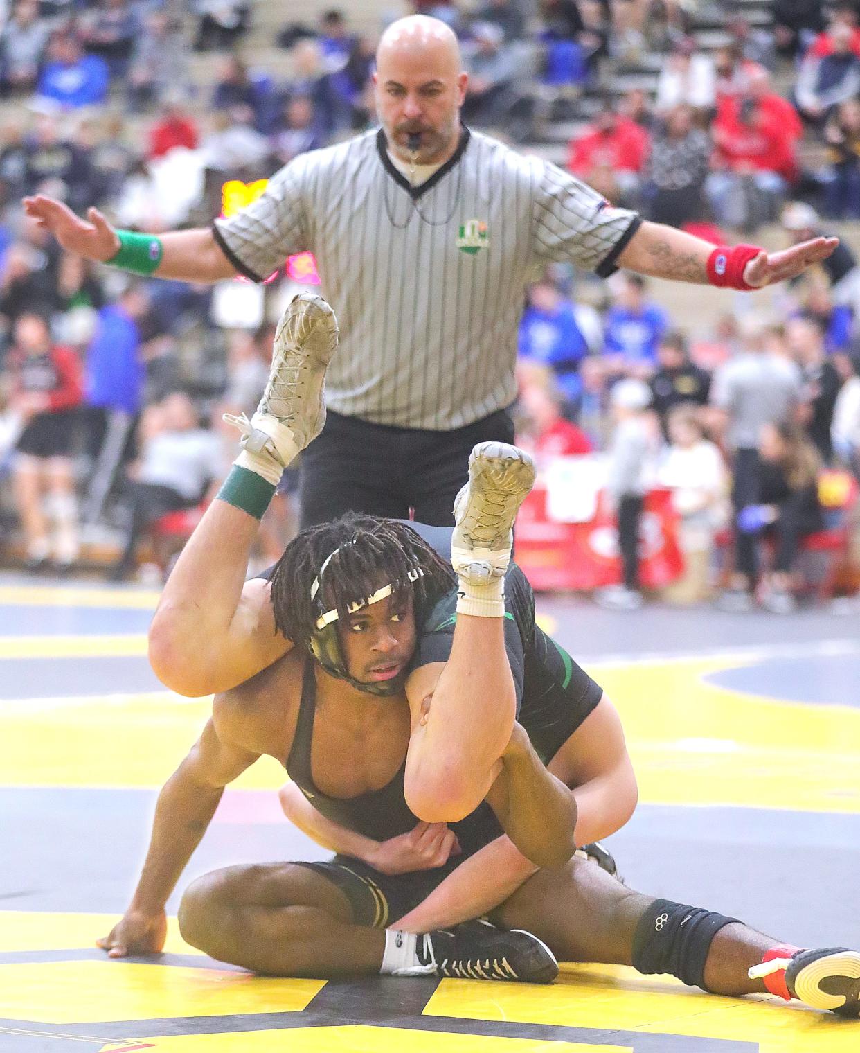 Perry 138-pounder Charles Curtis on his way to pinning Highland's Brennan Kicker on Dec. 29, 2023, in Brecksville.