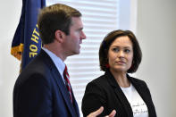 Lt. Governor Jacqueline Coleman, right, looks on as Kentucky Governor-Elect Andy Beshear speaks with reporters following the concession of incumbent Governor Matt Bevin in Frankfort, Ky., Thursday, Nov. 14, 2019. In a recanvass, Beshear defeated Bevin by 5136 votes. (AP Photo/Timothy D. Easley)