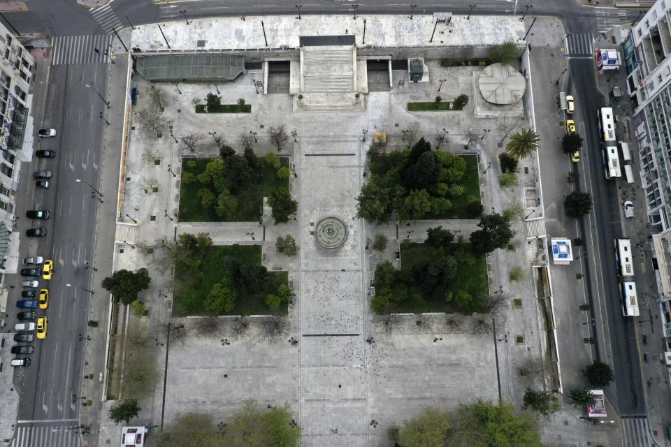 In this Wednesday, April 1, 2020 aerial photo, a virtually empty Syntagma square, in Athens. Deserted squares, padlocked parks, empty avenues where cars were once jammed bumper-to-bumper in heavy traffic. The Greek capital, like so many cities across the world, has seen its streets empty as part of a lockdown designed to stem the spread of the new coronavirus. (AP Photo/Thanassis Stavrakis)