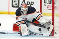 Edmonton Oilers goaltender Mike Smith deflects a shot during the second period in Game 3 of an NHL hockey Stanley Cup first-round playoff series against the Los Angeles Kings Friday, May 6, 2022, in Los Angeles. (AP Photo/Mark J. Terrill)