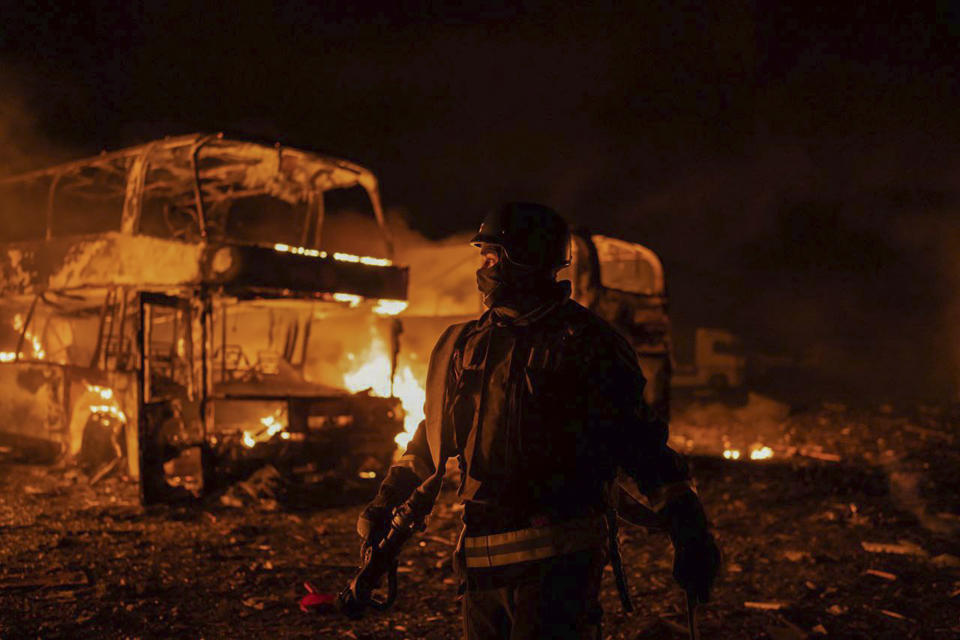 In this photo provided by the Ukrainian Emergency Situations Ministry, firefighters put out fire caused by fragments of a Russian rocket after it was shot down by air defense system during the night Russian rocket attack in Kyiv, Ukraine, early Tuesday, May 16, 2023. (Ukrainian Emergency Situations Ministry via AP)