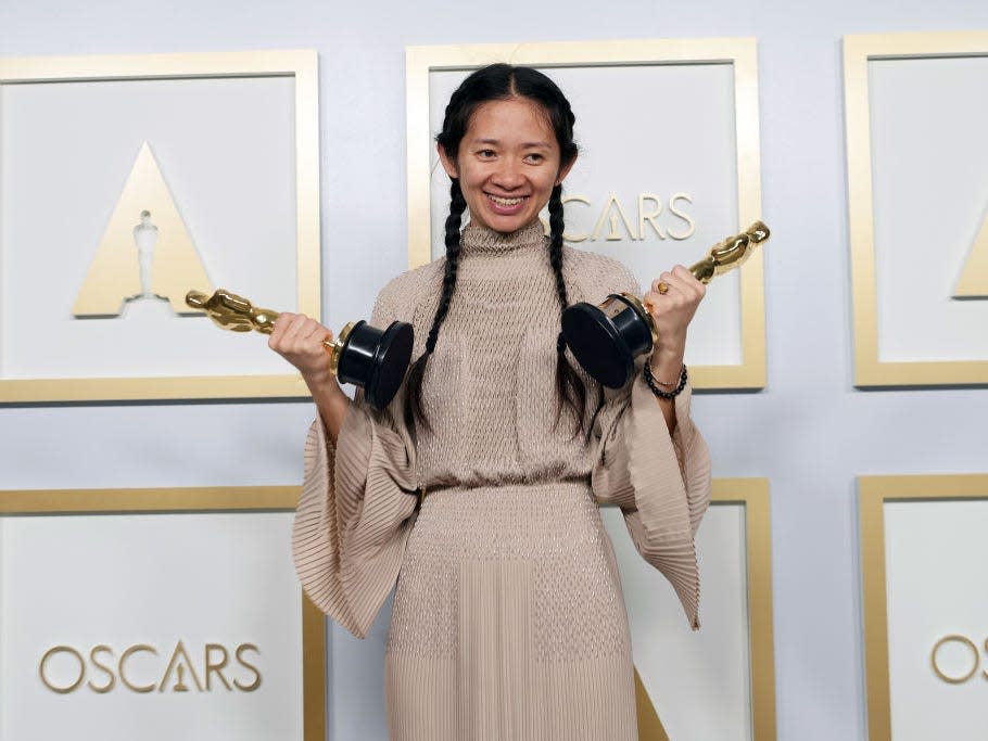 Chloé Zhao, winner of the best director for "Nomadland," poses with her Oscars.