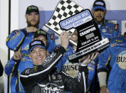 Kevin Harvick holds up his trophy after winning the first of two qualifying auto races for the NASCAR Daytona 500 at Daytona International Speedway, Thursday, Feb. 14, 2019, in Daytona Beach, Fla. (AP Photo/Terry Renna)