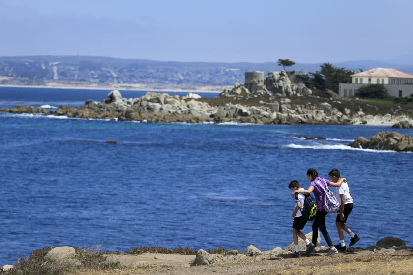 MONTEREY, CA -- TUESDAY, AUGUST 2, 2016: Tourists explore on the coast of Pacific Grove section of the Monterey Bay coastline on a summer day in Monterey. Steve Lopez takes a California coastal tour marking the 40th anniversary of the Coastal Act in California, CA, on Aug. 2, 2016. (Allen J. Schaben / Los Angeles Times)