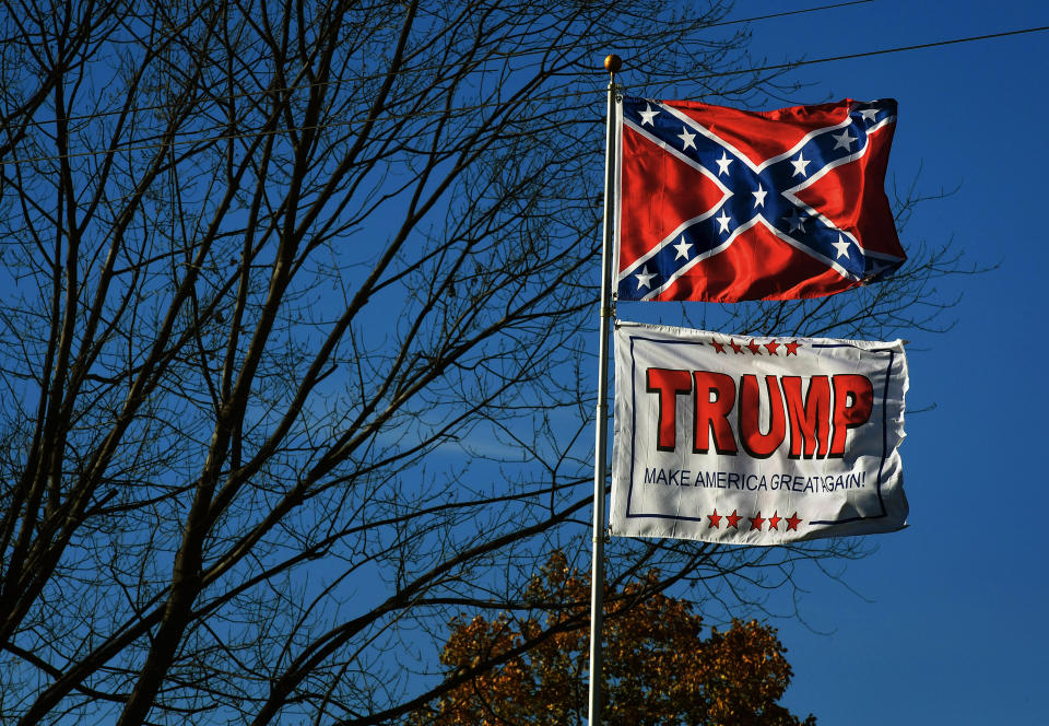The Confederate Flag and a Trump MAGA flag fly along the Lincoln Highway near a video store in Chester, West Virginia. (Photo by Michael S. Williamson/The Washington Post via Getty Images) (Photo: The Washington Post via Getty Images)