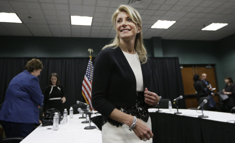 FILE - In this Jan. 9, 2014 file photo, Texas Sen. Wendy Davis smiles as she heads to speak to reporters after an education roundtable meeting in Arlington, Texas. Davis is expected to face Republican Greg Abbott in the Texas governor’s race. Battleground Texas, a major Democratic effort aimed at turning one of the reddest states blue, will face its first test in the Democratic primary on March 4. (AP Photo/LM Otero)