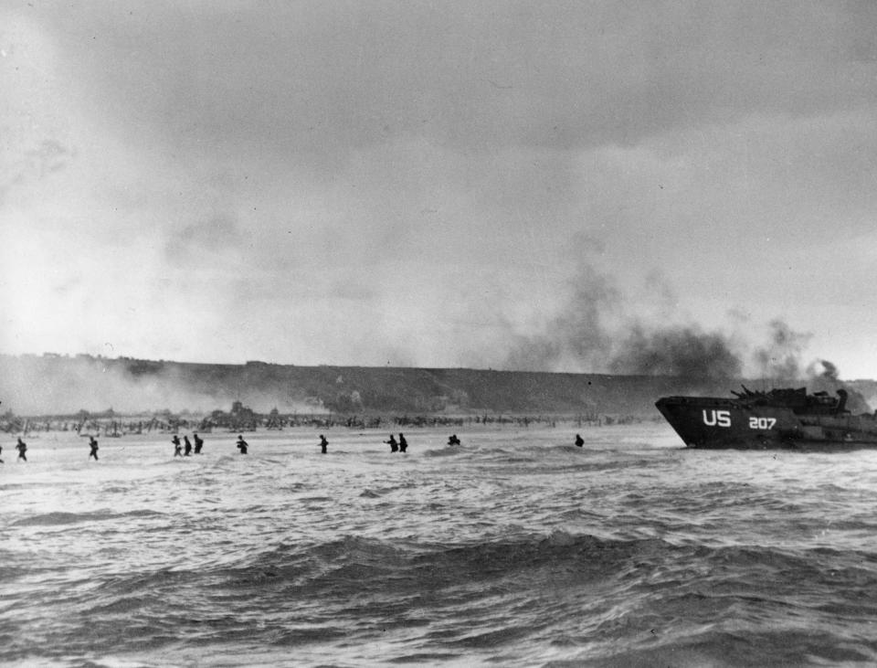 Under the cover of naval shell fire, American infantrymen wade ashore from their landing craft during the initial Normandy landing operations in France on June 6, 1944. (Photo: AP)