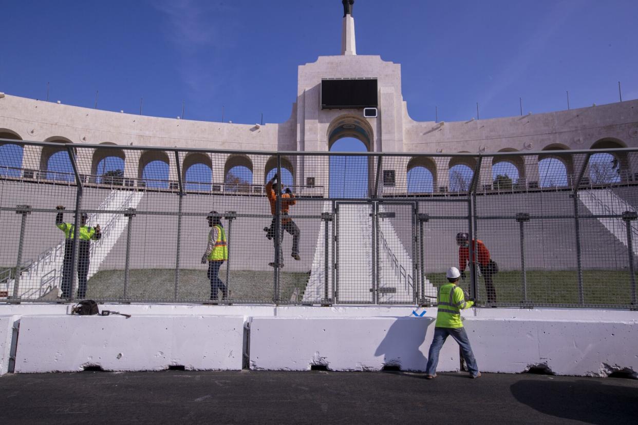 Construction crews transform the Coliseum from a football stadium to a quarter-mile short track NASCAR exhibition race track.