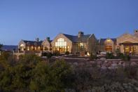 A glorious view of the home as the sun sets in the background.