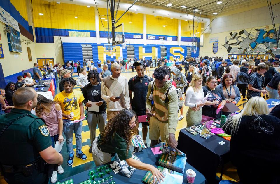 Mainland High School students speak with recruiters from businesses as well as Public Safety agencies and Colleges and University's during a career fair at the school in Daytona Beach, Tuesday, Nov. 14, 2023.
