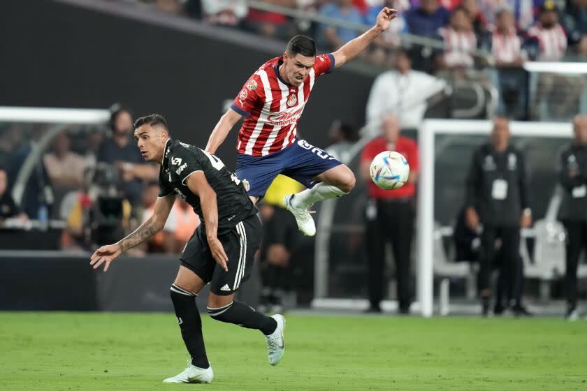 Juventus' Marco Da Graca, left, and Chivas' Eduardo Torres battle for the ball during the first half of a friendly soccer match Friday, July 22, 2022, in Las Vegas. (AP Photo/John Locher)