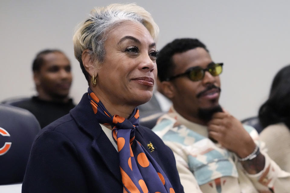 Greta Warren smiles as she listens to her husband, Chicago Bears new President & CEO Kevin Warren as he speaks during a news conference at Halas Hall in Lake Forest, Ill., Tuesday, Jan. 17, 2023. (AP Photo/Nam Y. Huh)