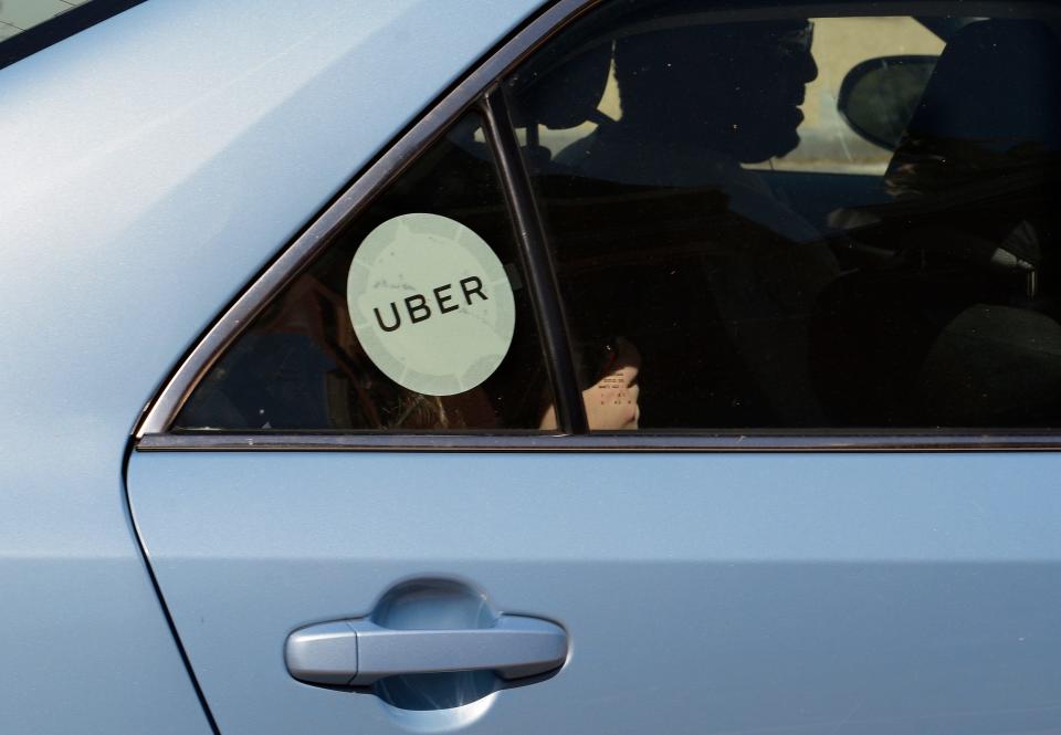 An Uber driver and car with passengers.