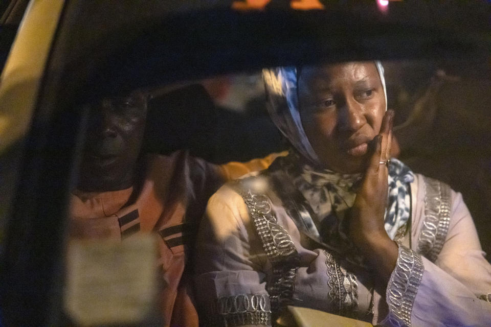 Mariama Sylla, sister of Ousmane Sylla, looks at the vehicle carrying her brother's casket from the airport in Conakry, Guinea, Monday, April 8, 2024. (AP Photo/Misper Apawu)