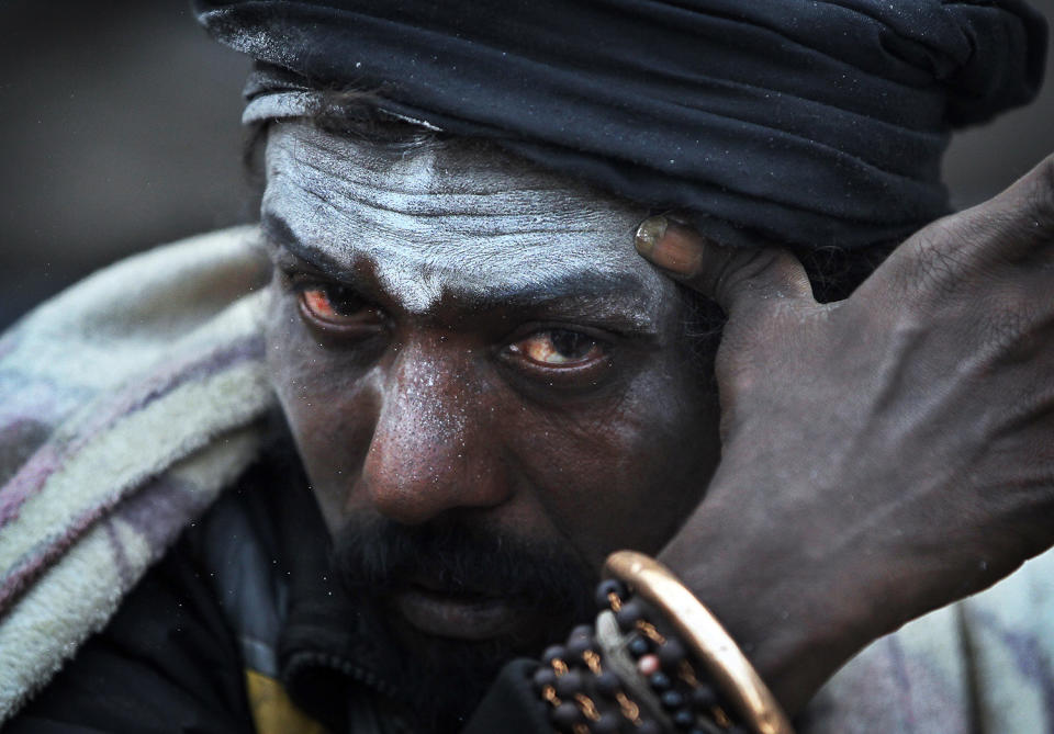 <p>A Hindu holy man smears his forehead with ash at the courtyard of the Pashupatinath Temple during the Maha Shivaratri festival in Kathmandu, Nepal, Friday, Feb. 24, 2017. Shivaratri, or the night of Shiva, is dedicated to the worship of Lord Shiva, the Hindu god of death and destruction. (AP Photo/Niranjan Shrestha) </p>