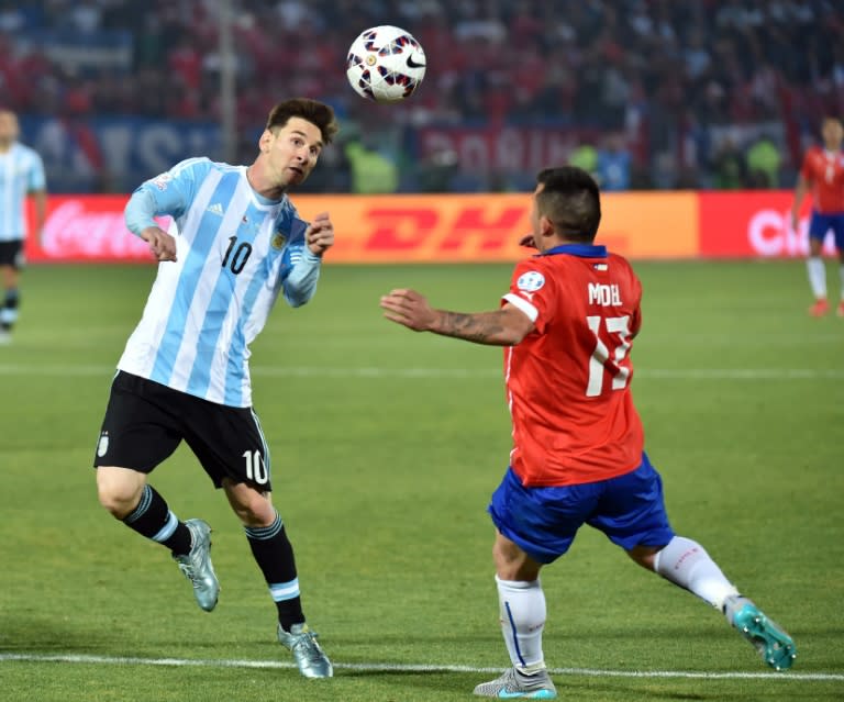 Argentina's Lionel Messi (L) fights for the ball with Chile's Gary Medel during their Copa America final match, in Santiago, on July 4, 2015