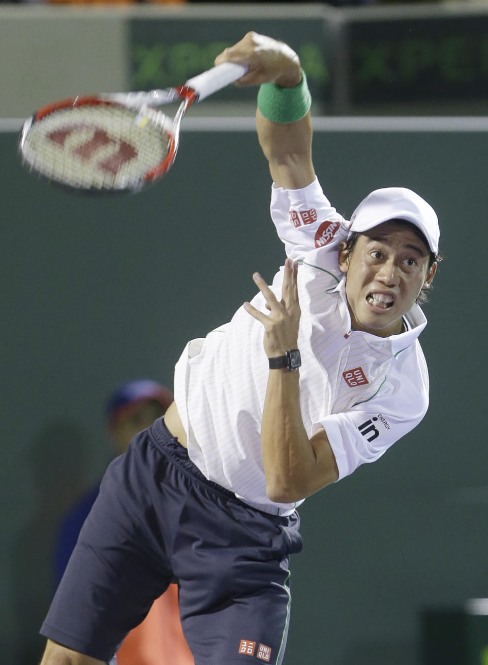 Kei Nishikori of Japan, serves to Roger Federer of Switzerland, at the Sony Open Tennis tournament, Wednesday, March 26, 2014 in Key Biscayne, Fla. (AP Photo/Wilfredo Lee)