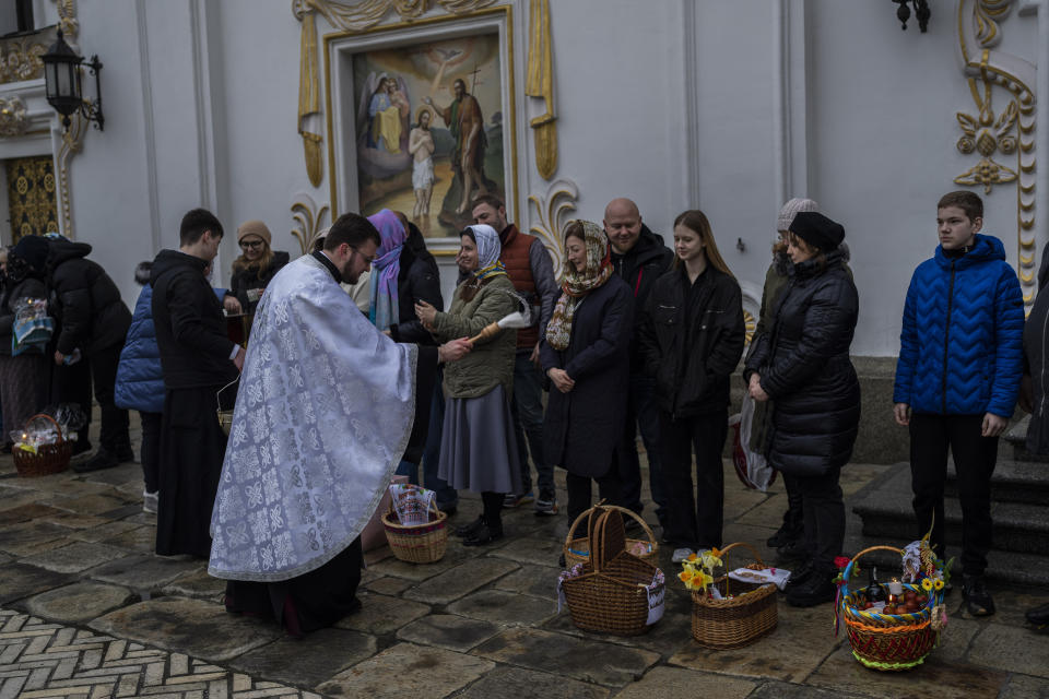 Orthodox Christian worshipers and their traditional Easter baskets are blessed during Easter Sunday at the Pechersk Lavra monastic complex Kyiv, Sunday, April 16, 2023. (AP Photo/Bernat Armangue)