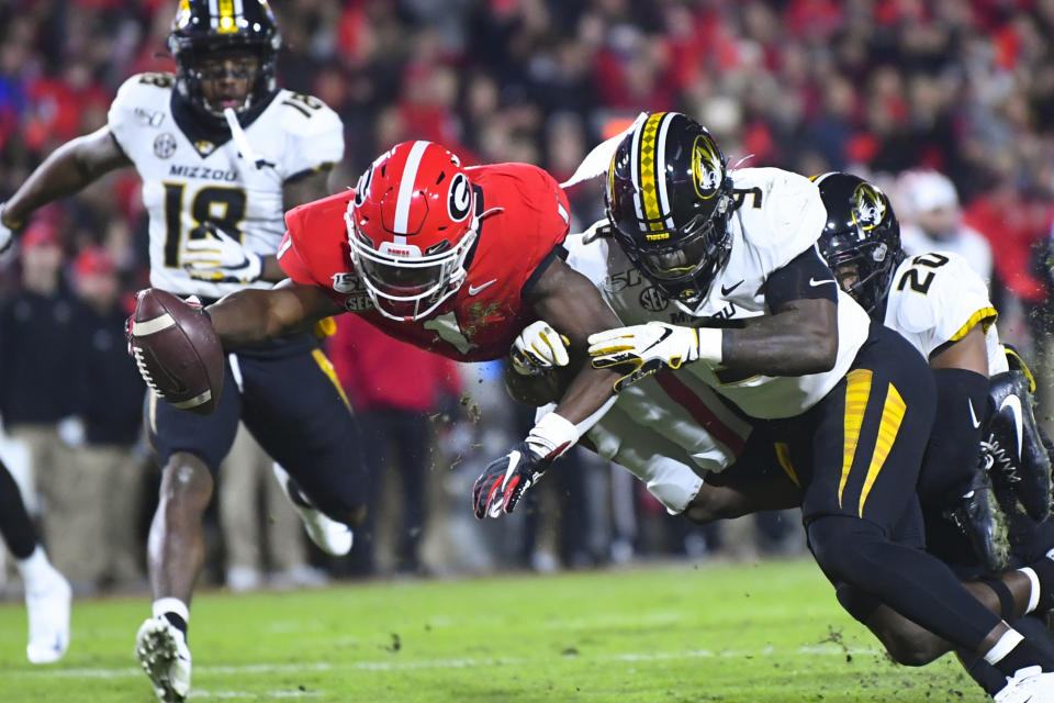 Georgia wide receiver George Pickens dives for a touchdown as Missouri safety Tyree Gillespie (9) defends during the first quarter of an NCAA college football game Saturday, Nov. 9, 2019, in Athens, Ga. (AP Photo/John Amis)