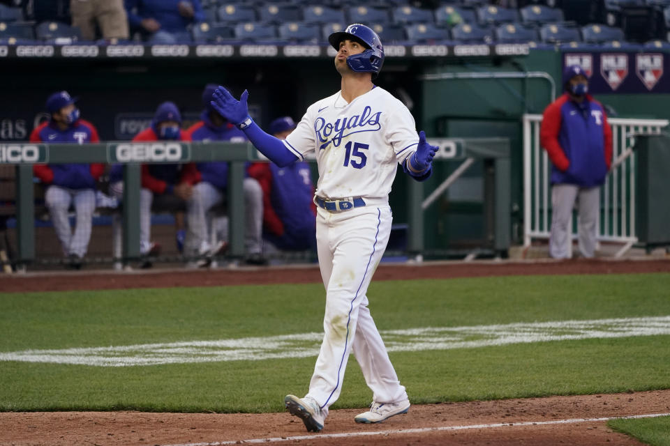 Kansas City Royals' Whit Merrifield celebrates as he runs home with a solo home run during the eighth inning of the team's baseball game against the Texas Rangers on Thursday, April 1, 2021, in Kansas City, Mo. (AP Photo/Charlie Riedel)