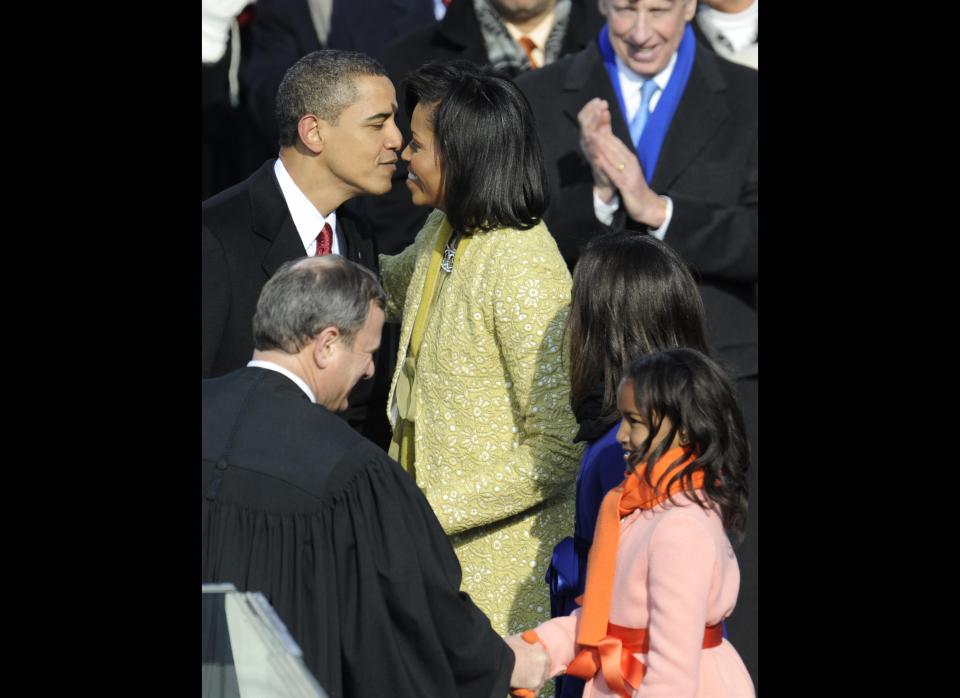 Barack Obama kisses his wife Michelle before daughters Sasha (R) and Malia (2nd-R) after Obama was sworn in as the 44th US president by Supreme Court Chief Justice John Roberts (L) at the US Capitol in Washington on January 20, 2009.       AFP PHOTO / TIMOTHY A. CLARY (Photo credit should read TIMOTHY A. CLARY/AFP/Getty Images)