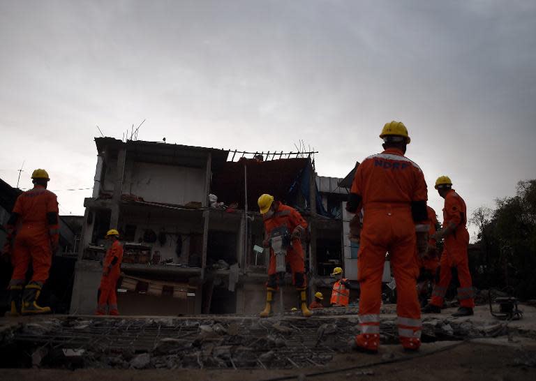 India's National Disaster Response Force personnel search for earthquake survivors as they clear rubble from a destroyed building in Kathmandu on April 28, 2015