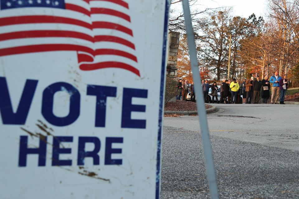 Voters wait in line to cast their ballot at a polling station setup in the St Thomas Episcopal Church on December 12, 2017 in Birmingham, Alabama.