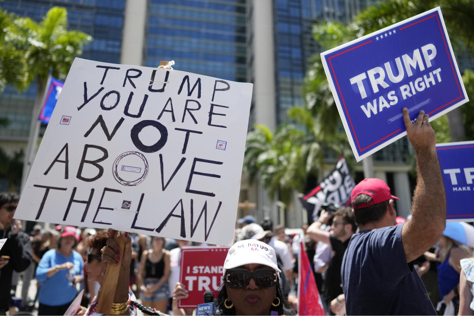 FILE - People rally outside the Wilkie D. Ferguson Jr. U.S. Courthouse, Tuesday, June 13, 2023, in Miami. As Trump becomes the first former president to face federal charges that could put him in jail, many Europeans are watching the case closely. But hardly a single world leader has said a word recently about the man leading the race for the Republican party nomination.. (AP Photo/Rebecca Blackwell, File)