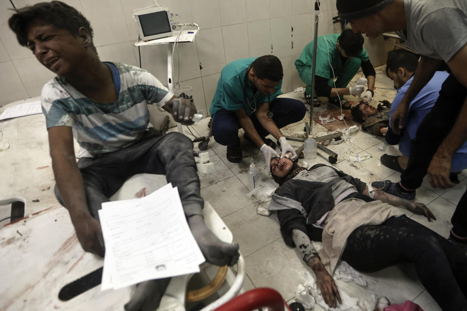 Palestinians wounded in the Israeli bombardment of the Gaza Strip receive treatment at the Nasser hospital in Khan Younis, Southern Gaza Strip, Sunday, Dec. 31, 2023. (AP Photo/Mohammed Dahman)