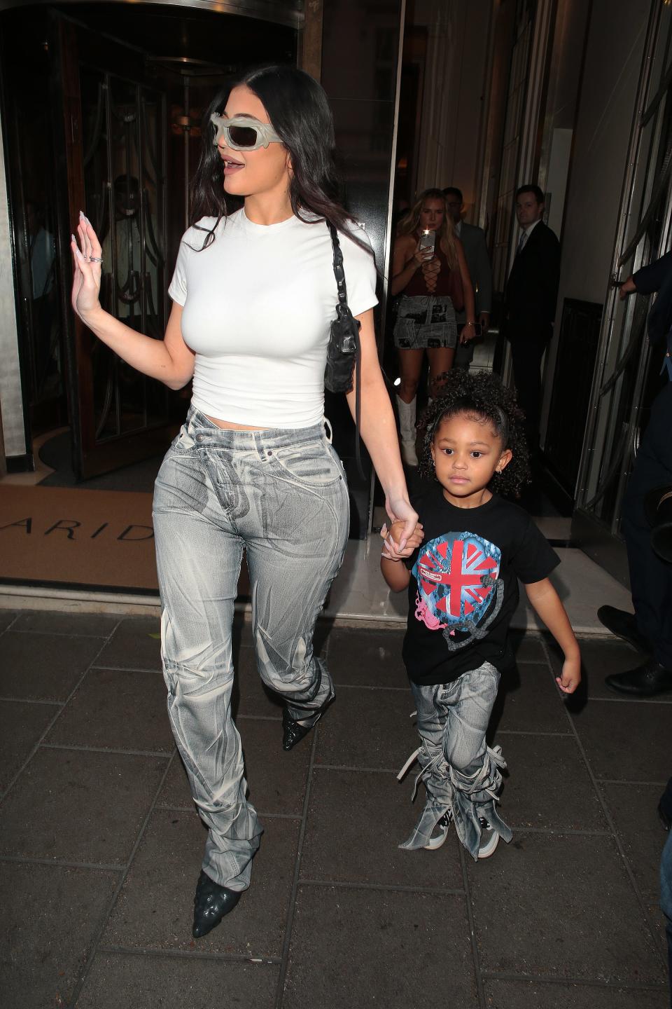 The duo wore similar grey-washed jeans to support Scott in concert.