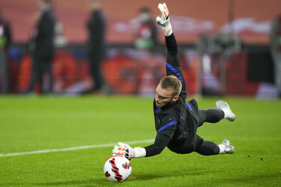 FILE - Netherlands' goalkeeper Jasper Cillesen dives to field the ball as he warms up ahead of the World Cup 2022 group G qualifying soccer match between the Netherlands and Norway at De Kuip stadium in Rotterdam, Netherlands, Tuesday, Nov. 16, 2021. (AP Photo/Peter Dejong, File)
