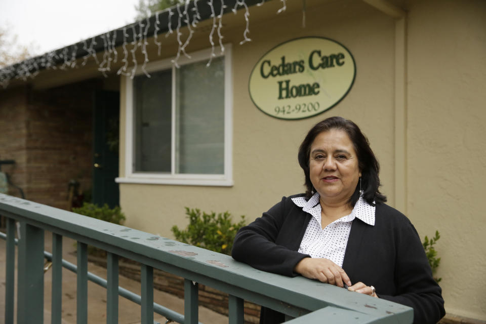 In this photo taken Thursday, Dec. 5, 2019, administrator Irais Lopez-Ortega stands outside the Cedars Care Home she runs in Calistoga, Calif. Even before widespread blackouts hit California this fall, the utility that triggered them showed signs it wasn’t fully prepared. An Associated Press review reveals persistent problems during four smaller shutoffs that Pacific Gas & Electric did starting last year so power lines downed by strong winds wouldn’t spark wildfires. (AP Photo/Eric Risberg)