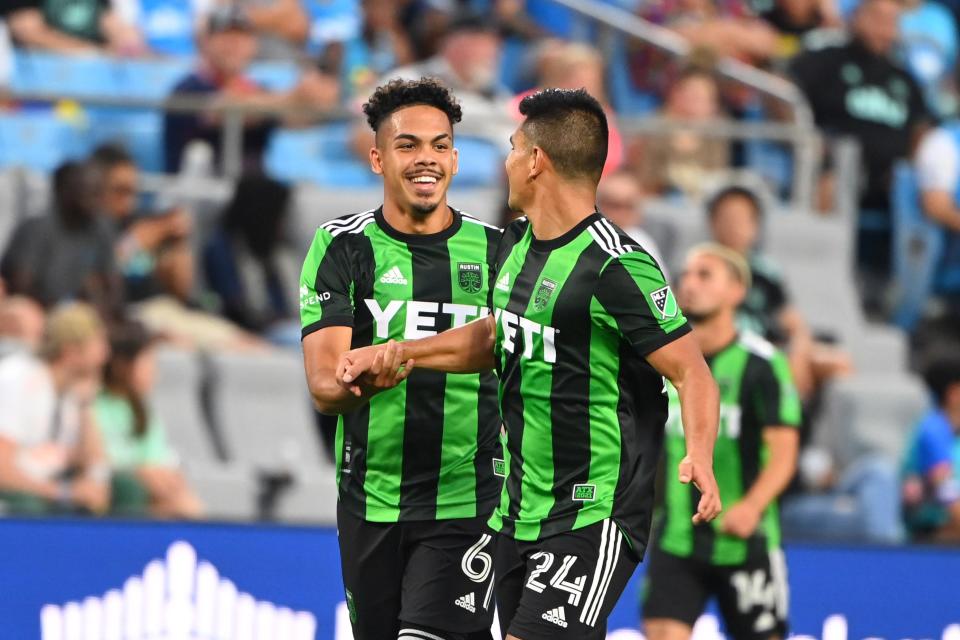 Austin FC midfielder Dani Pereira, left, celebrates his goal with defender Nick Lima during Thursday night's 1-0 win at FC Charlotte. El Tree ended the first half of the MLS season in second place in the Western Conference.