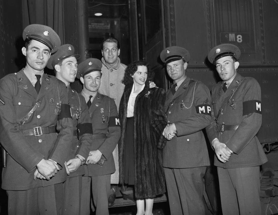 Jan. 30, 1942: Judy Garland and her husband, David Rose, are visiting Fort Worth. Garland is set to perform in a USO show for the soldiers at Camp Wolters in Mineral Wells. The couple is shown arriving at the Texas and Pacific Railway Station with an escort of Fort Worth Military Police. Ms. Garland is the first honorary woman member of the military police of World War II. The officers are, from left, Pvt. L.M. Howell, Cpl. L.A. Owen, Pvt. Jack Betz, Pvt. N.O. Shepherd, and Pvt. Robert Cooper. Fort Worth Star-Telegram archives/UT Arlington Special Collections