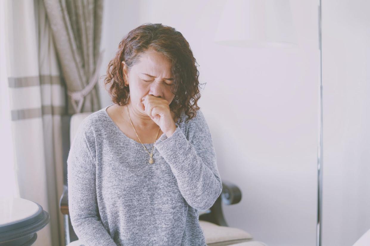 Around 20% of women with lung cancer have never smoked. <a href="https://www.gettyimages.com/detail/photo/woman-coughing-while-sitting-against-wall-at-home-royalty-free-image/1188576496" rel="nofollow noopener" target="_blank" data-ylk="slk:Mallika Wiriyathitipirn/EyeEm via Getty Images;elm:context_link;itc:0;sec:content-canvas" class="link ">Mallika Wiriyathitipirn/EyeEm via Getty Images</a>