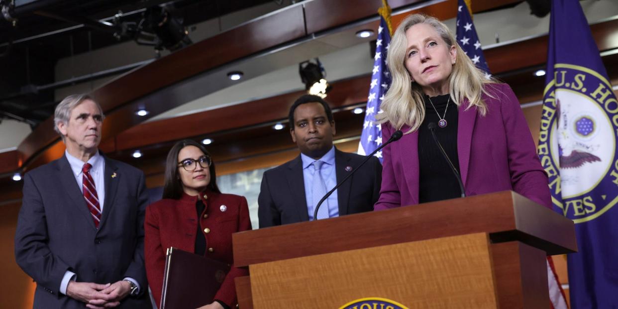 Democratic Rep. Abigail Spanberger of Virginia speaks at a press conference on banning lawmakers from trading stocks as Democratic Sen. Jeff Merkley of Oregon and Democratic Reps. Alexandria Ocasio-Cortez of New York and Joe Neguse of Colorado look on.