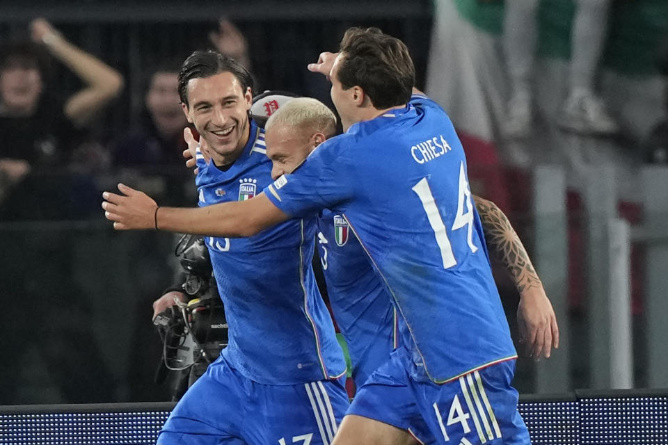 Italy's Matteo Darmian celebrates with his teammates Federico Dimarco and Italy's Federico Chiesa after scoring his sides first goal during an Euro 2024 group C qualifying soccer match between Italy and North Macedonia, at the Olympic Stadium stadium in Rome Friday, Nov. 17, 2023. (AP Photo/Andrew Medichini)