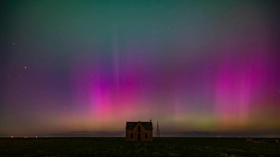 The aurora borealis can be seen in the northern sky near the Marion and Chase County line on Friday night. The abandoned stone limestone house in the pasture was built in 1878.