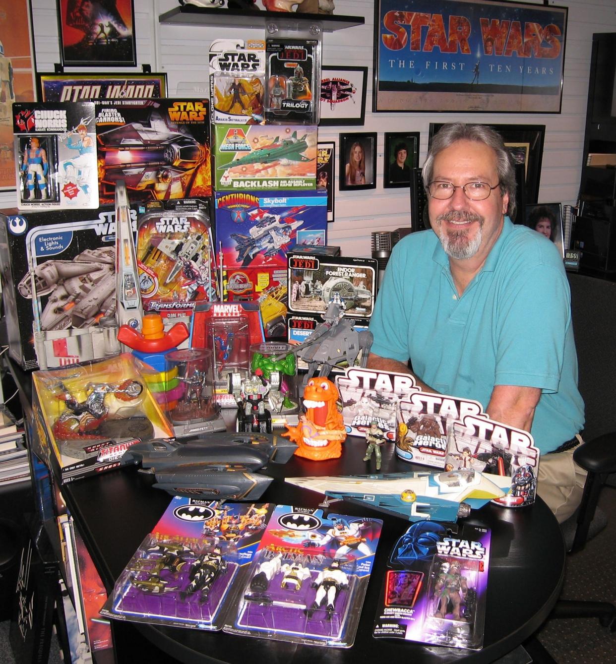 Mark Boudreaux poses with some of the many Star Wars and other toys he created for Hasbro.