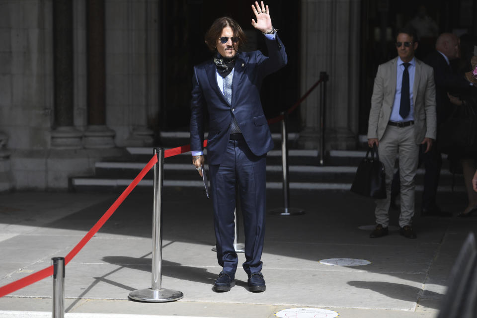 Actor Johnny Depp arrives at the High Court for a hearing in his libel case, in London, Friday, July 24, 2020. Depp is suing News Group Newspapers, publisher of The Sun, and the paper's executive editor, Dan Wootton, over an April 2018 article that called him a "wife-beater." The Sun's defense relies on a total of 14 allegations by his ex-wife, actress Amber Heard of Depp's violence. He strongly denies all of them. (Kirsty O'Connor/PA via AP)