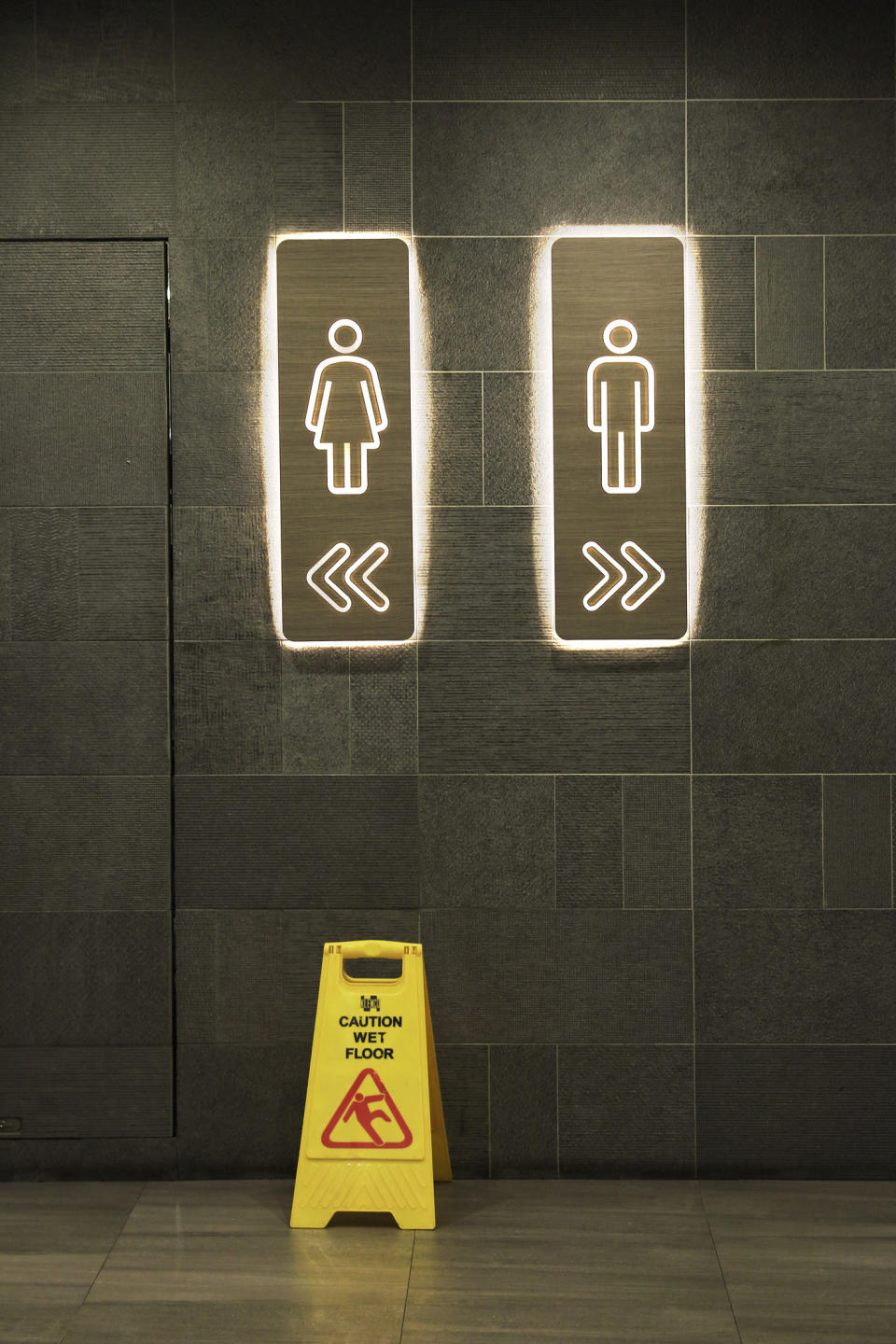 Signs pointing to public restrooms.