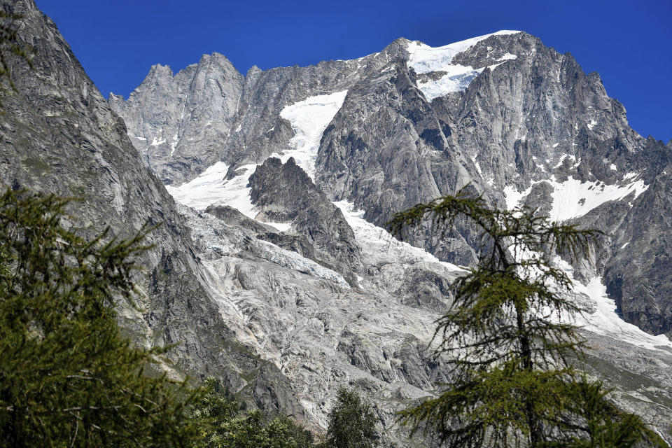 The Planpincieux glacier, located in the Alps on the Grande Jorasses peak of the Mont Blanc massif, is seen from Val Ferret, a popular hiking area on the south side of the Mont Blanc, near Courmayeur, northern Italy, Friday, Aug. 7, 2020. Some 70 people were evacuated Thursday in the valley below the glacier and roads closed after the threat of collapse the the fast-moving melting glacier is posing to the picturesque valley near the Alpine town of Courmayeur. (Claudio Furlan/LaPresse via AP)